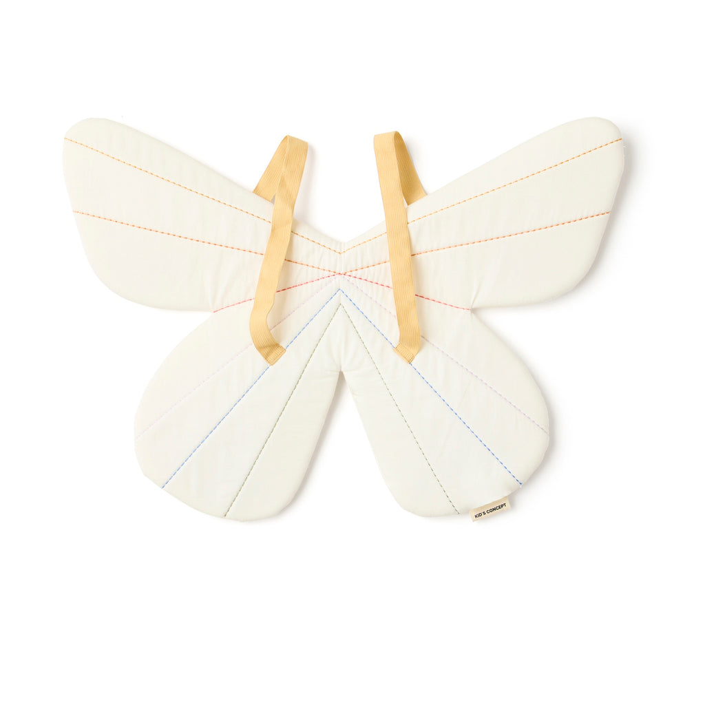 Quilted butterfly-shaped costume with pastel stitching in red and blue on cream fabric. Two beige straps attached, resembling wings. Playful tone.