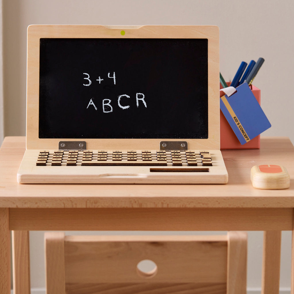 Wooden toy laptop set includes a laptop, smartphone, and mouse. The laptop has a black screen and keyboard. Playful and educational.