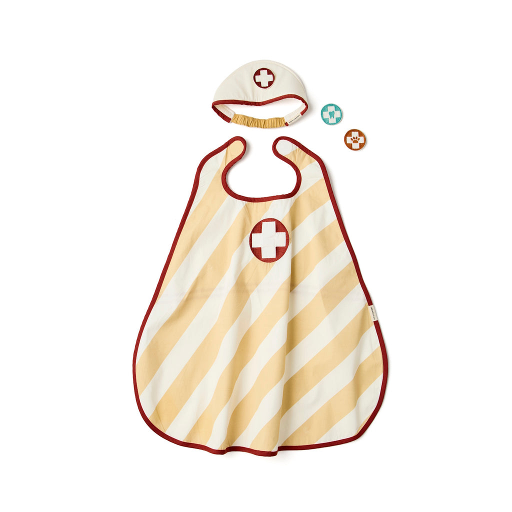 Children's doctor costume set with a striped apron and matching hat, both featuring a white cross on a red circle, includes two circular badges.