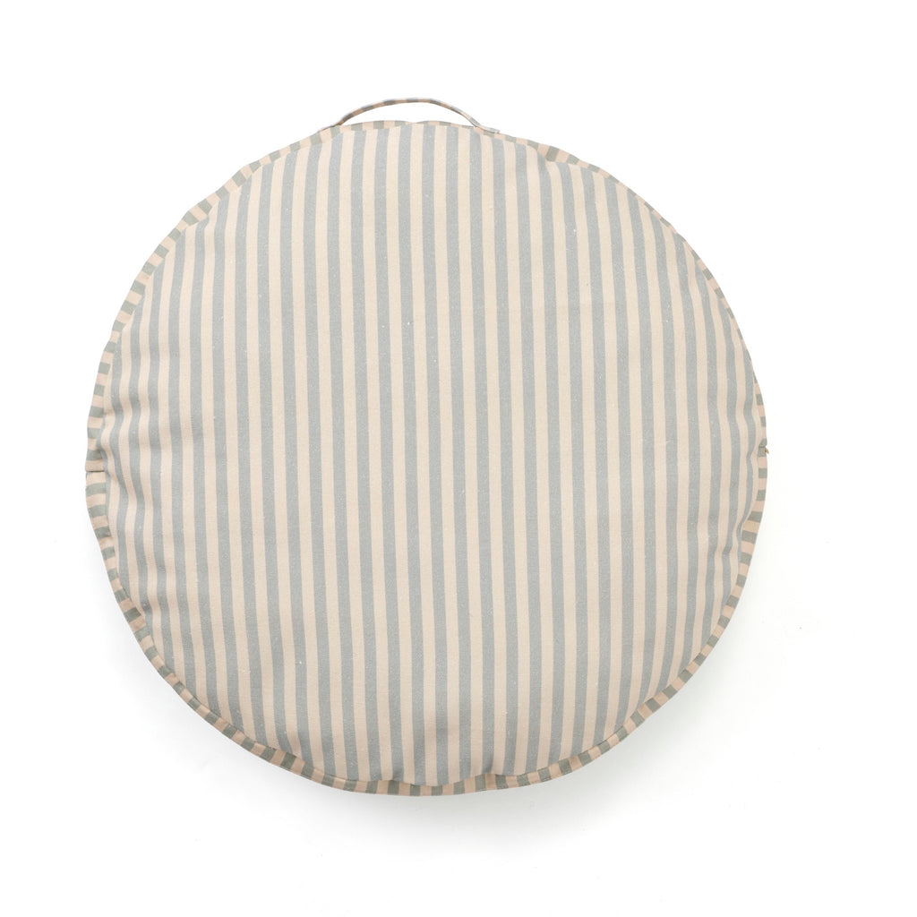 Round cushion with beige and gray horizontal stripes on a white background. The cushion has a calm, minimalist design, and includes a side handle.