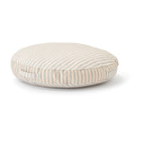 Round, beige and grey striped floor cushion with a side carrying handle, set against a plain white background.