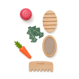 Wooden pet care set featuring brushes, a comb, toy leaves, an apple, and a carrot.