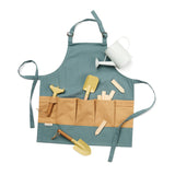 Blue kids gardening apron with beige pockets holding yellow tools, plant labels, and a watering can.
