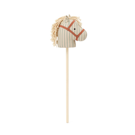 Striped fabric hobby horse head with yarn mane on a wooden stick against a white background.