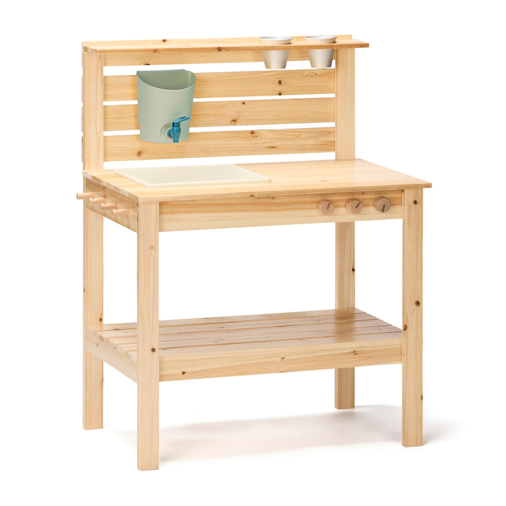 Wooden play kitchen with natural finish, featuring a countertop with a sink, knobs, and shelf. Buckets and pots hang from slats, conveying a playful, rustic charm.