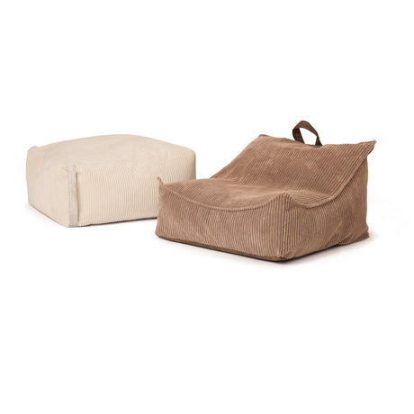 Off-white square Ottoman pouffe next to a brown corduroy floor lounge chair.