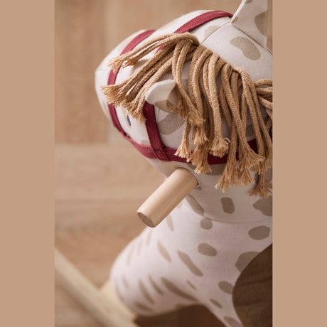Plush Kids Concept Dotty rocking horse with yarn mane, red bridle, and wooden handle.