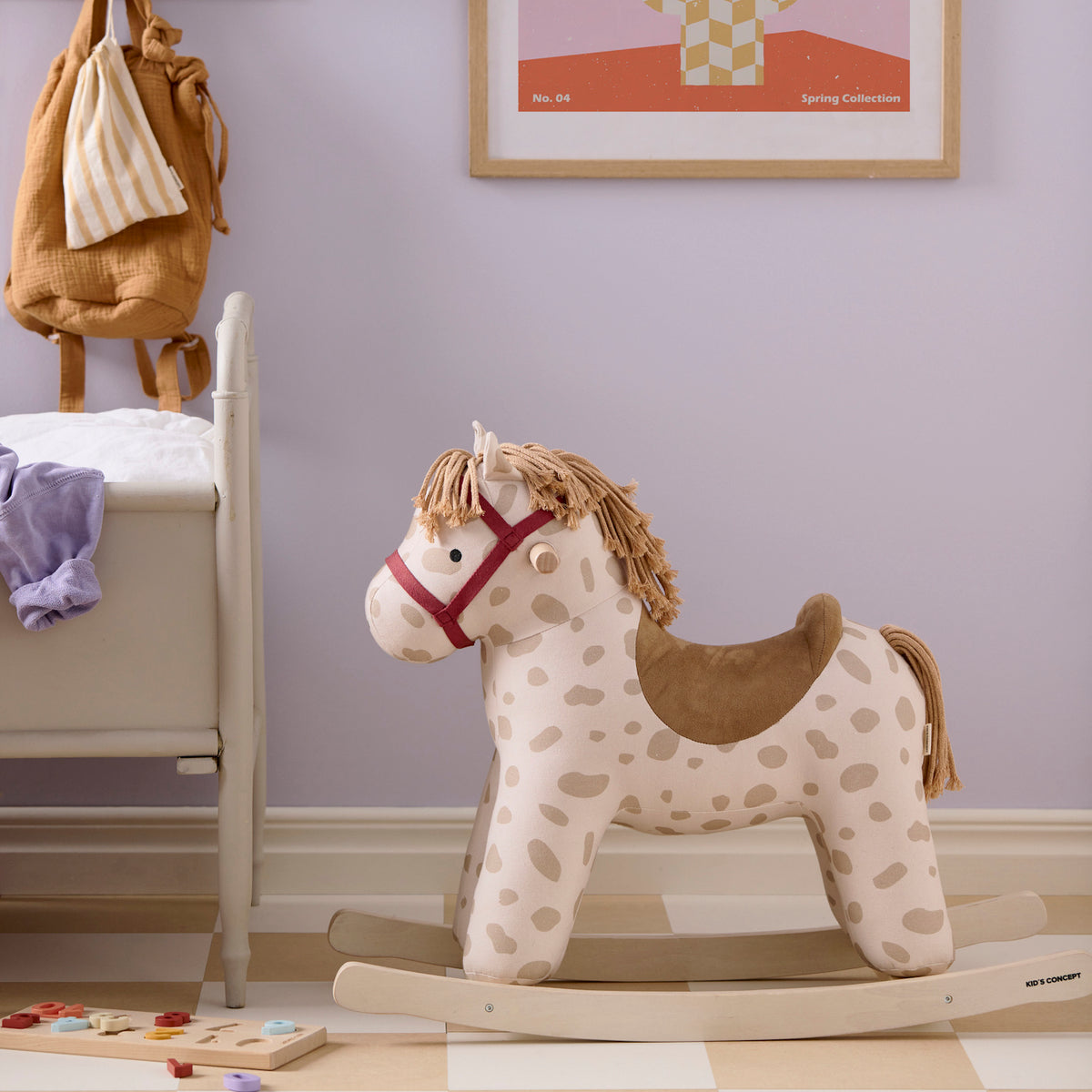 Plush Kids Concept Dotty rocking horse with beige spots in a nursery room.