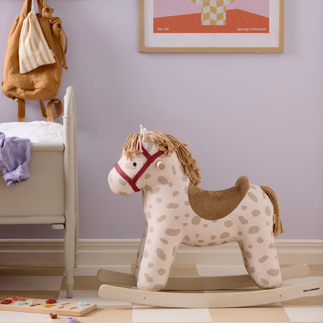 Plush Kids Concept Dotty rocking horse with beige spots in a nursery room.