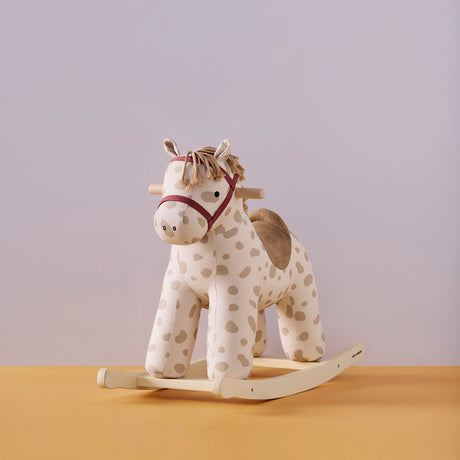 Plush spotted rocking horse toy with a wooden base, fabric saddle, and reins.