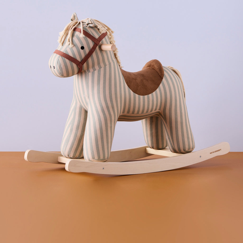 Soft, striped rocking horse with a beige and blue pattern, wooden rockers, and a plush brown saddle. It evokes a playful, nostalgic feel.