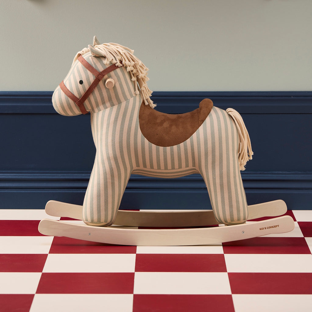Soft, striped rocking horse with a beige and blue pattern, wooden rockers, and a plush brown saddle. It evokes a playful, nostalgic feel.