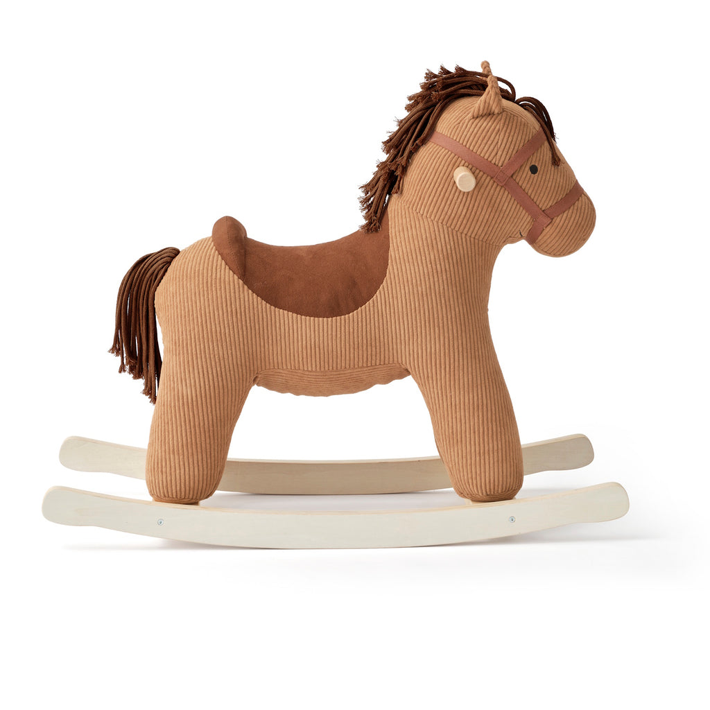 Plush rocking horse toy with a brown corduroy texture, wooden rocking base, and stitched details. The horse has a soft saddle and mane, evoking a cozy, playful feel.