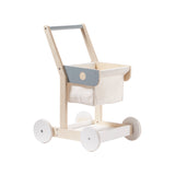 Wooden toy shopping trolley with a cream fabric basket, grey accents, and white wheels.