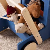 Blue wooden toy walker truck filled with plush toys including a doll, horse, and bear.