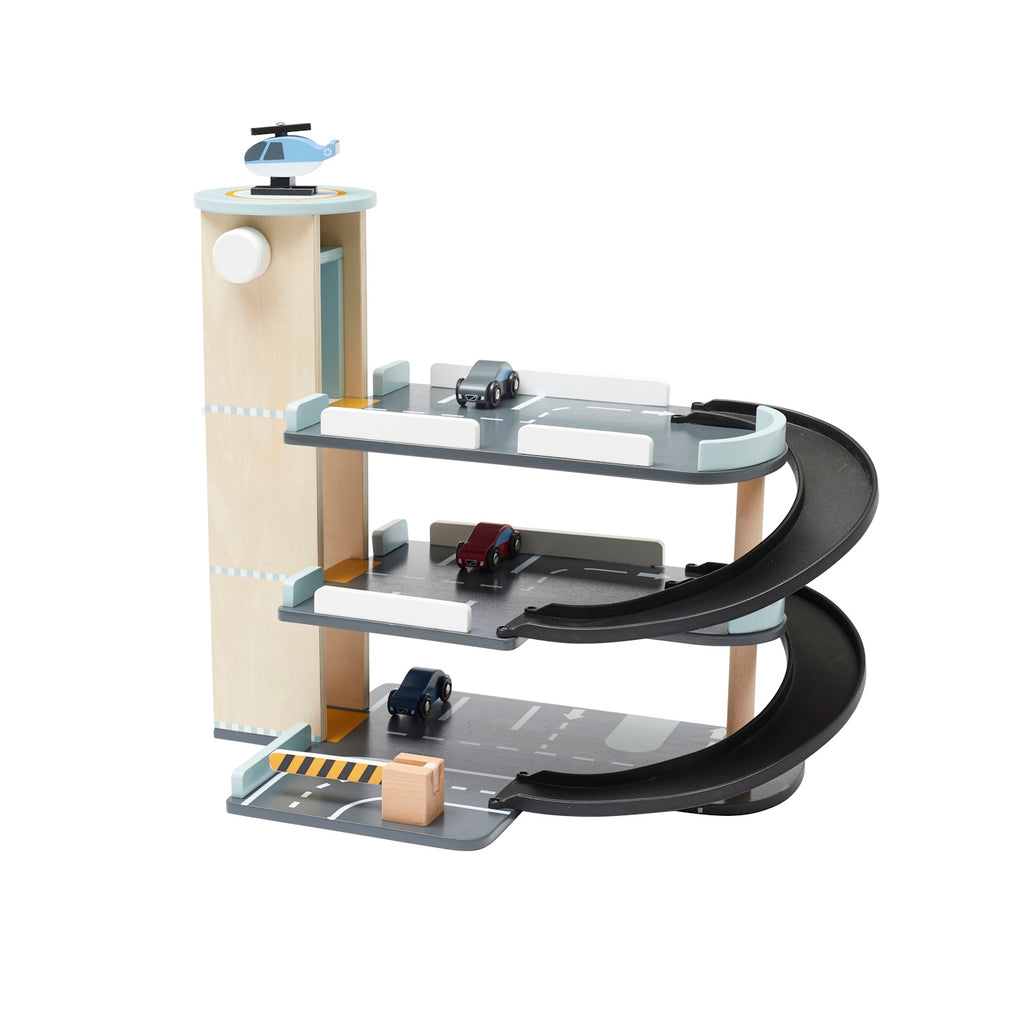 Wooden toy parking garage with three levels, spiral ramp, three toy cars, a helicopter on the rooftop helipad, and a traffic barrier for pretend play.