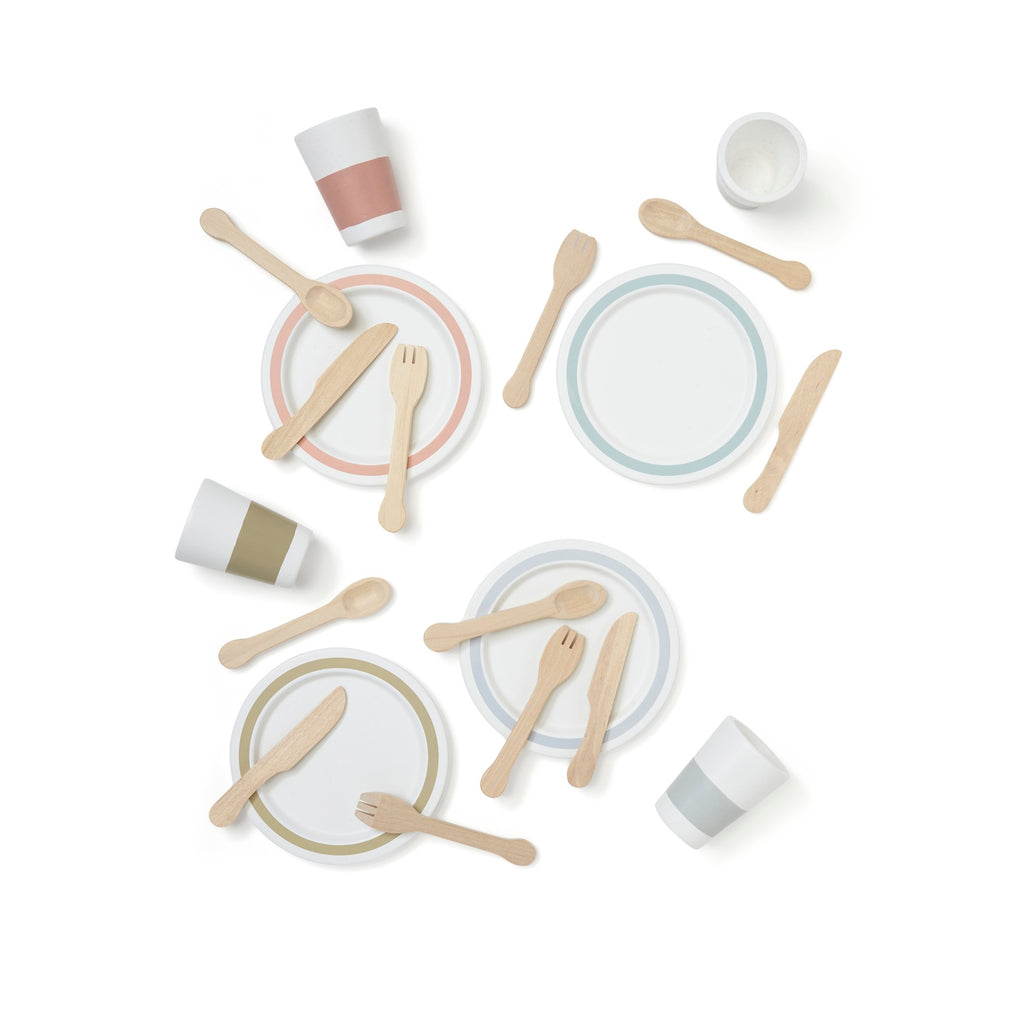 Toy dining set with wooden forks, knives, and spoons on two plates. Four pastel-toned cups complement the minimalist, playful design, on a white background.