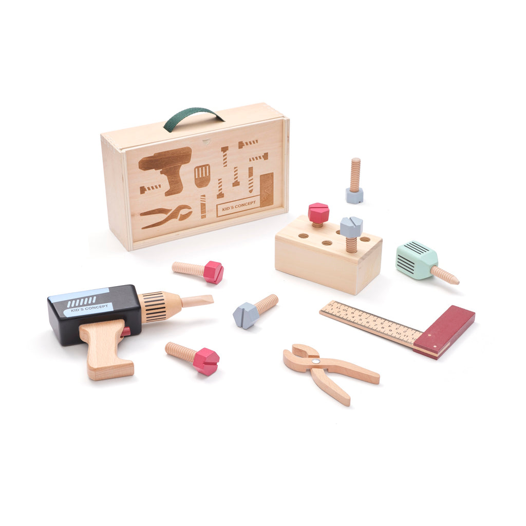 Wooden toy tool set with a drill, ruler, pliers, and screws, arranged in front of a toolbox on a white background, conveying creativity and play.