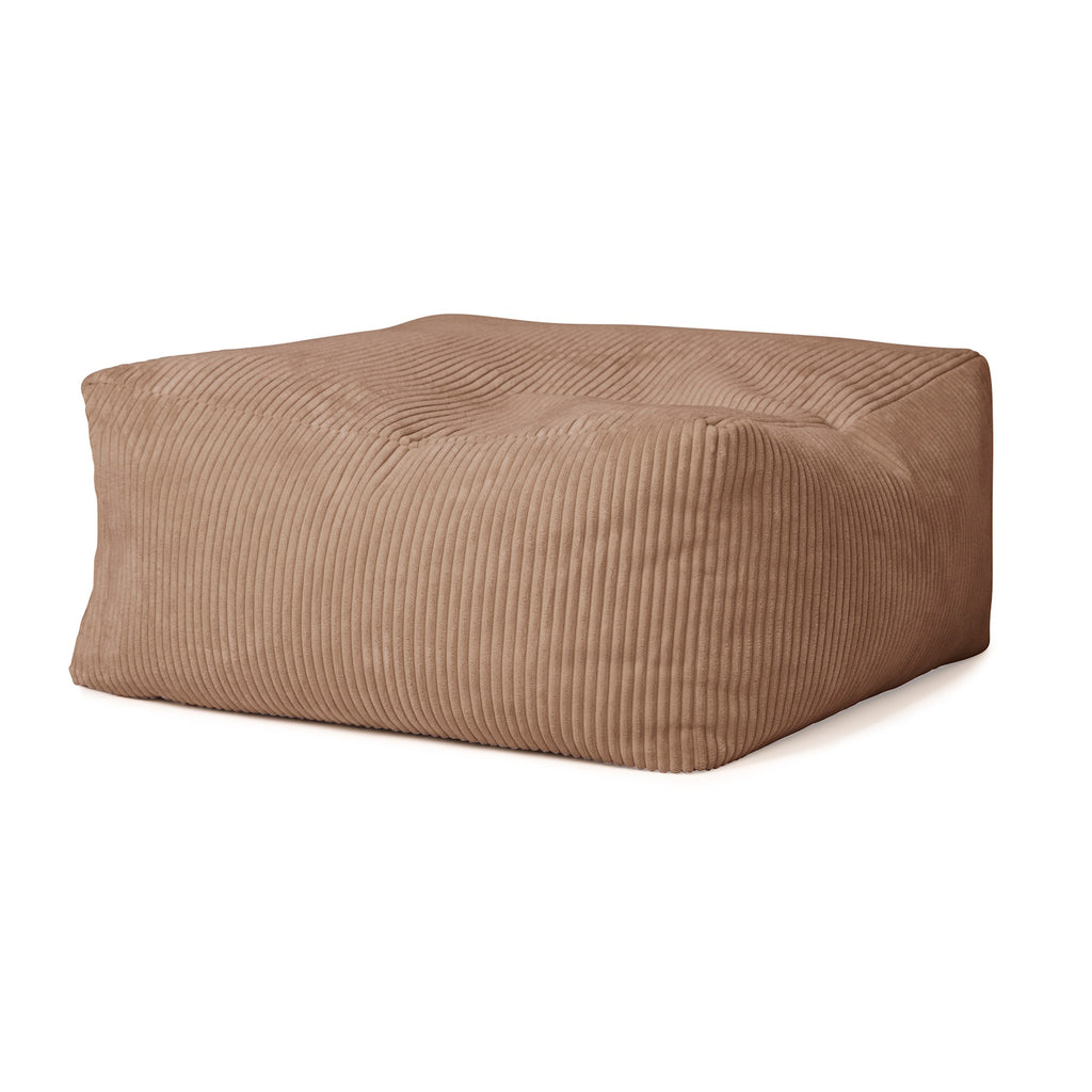 A plush, rectangular brown pouf with a ribbed texture. Its soft, inviting appearance suggests comfort, adding warmth to any room decor.