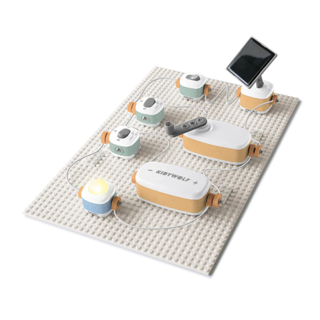 An educational toy electronics kit assembled on a building plate with a hand crank, solar panel, and lit bulb.