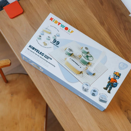 A Kidywolf Kidyelec Starter Pack toy box on a wooden table.