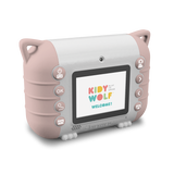 A children’s digital camera with a pink and white design is set against a white background. Its screen displays the colorful text “Kidy Wolf Welcome!” with various control buttons on the sides.