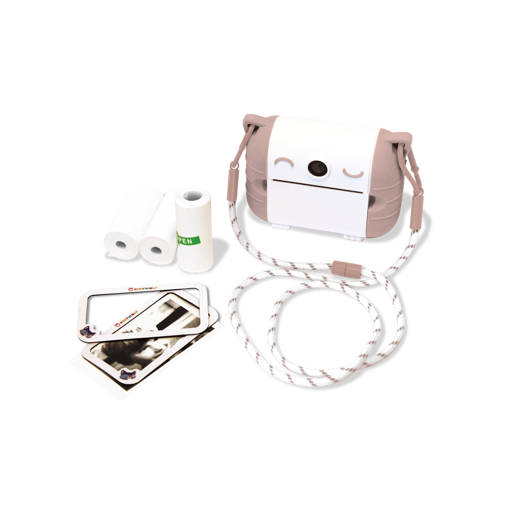 Cute camera with a smiling face and brown ears, surrounded by photo paper rolls, a striped strap, and photos, set against a white background.