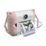 Cute pink and white toy camera with cat ears, printing a black and white photo of a child smiling. The design is playful and whimsical.