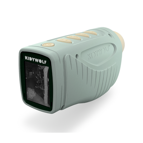 A light green KIDYWOLF night vision device with a screen showing a grayscale image of trees. The device has embossed grip lines and buttons.