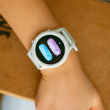 A mint green smartwatch on a wrist, displaying activity options like treadmill and sit still.