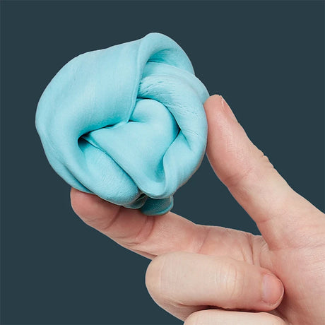 Hand holding a swirled ball of sky-blue focus putty against a dark grey background.