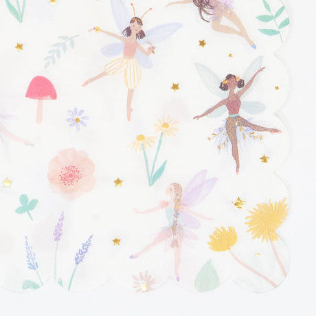 A white scalloped napkin featuring illustrations of dancing fairies, mushrooms, flowers, and gold stars.