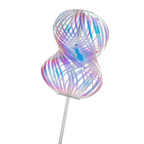 A colorful, twisted spiral sculpture with iridescent ribbons and a translucent appearance, mounted on a slender vertical pole, against a plain backdrop.