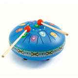Blue steel tongue drum for kids with colorful numbered notes and two wooden mallets on white background.