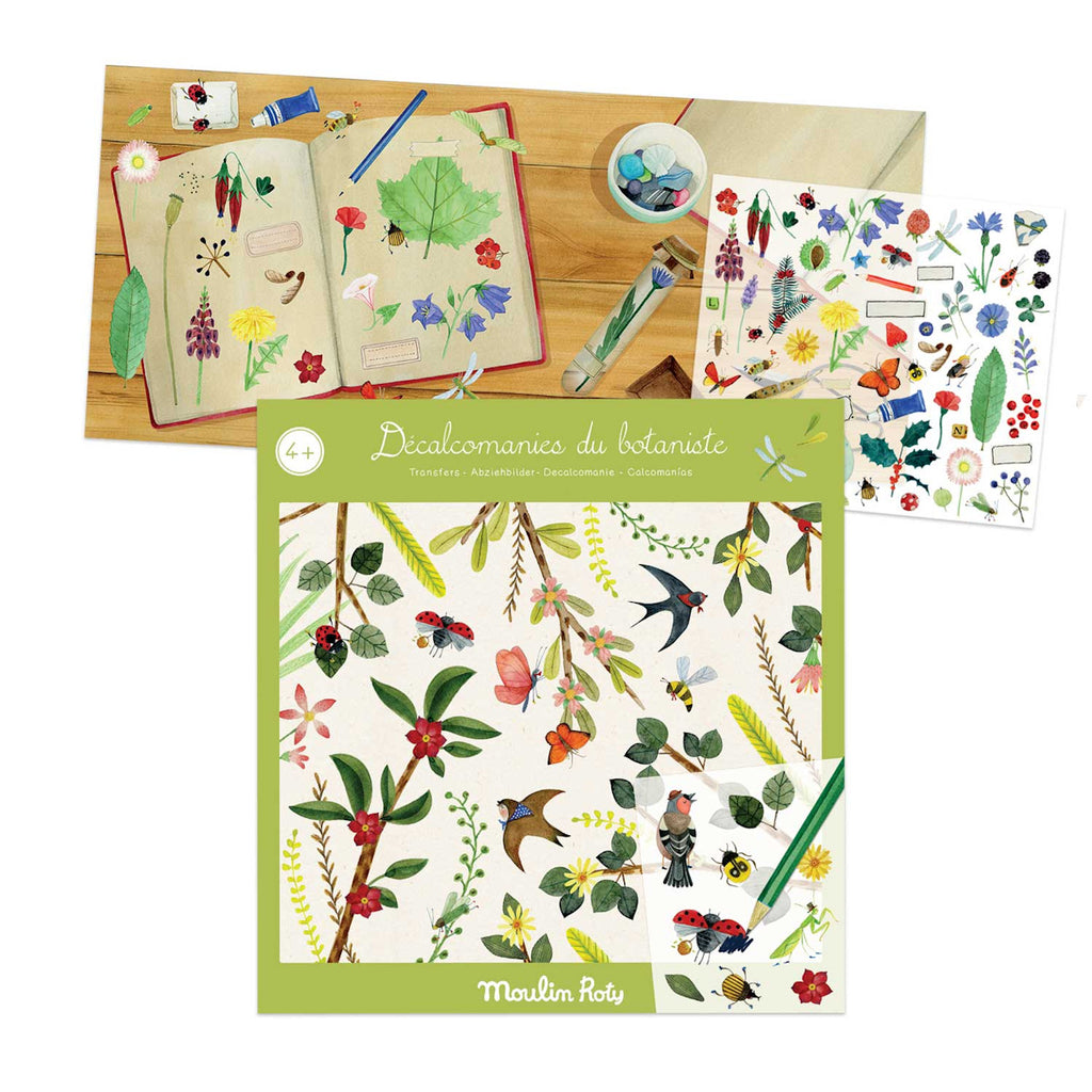 Botanical decal set with illustrated flowers, birds, and leaves on a table. An open notebook shows nature sketches, evoking creativity and exploration.