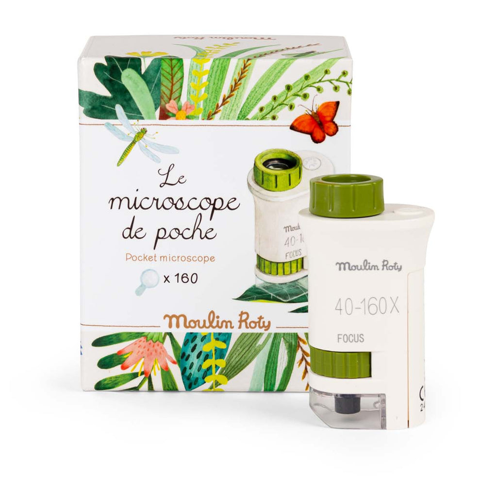 A pocket microscope with green accents is in front of a decorative box featuring colorful leaves, a dragonfly, and a red butterfly.