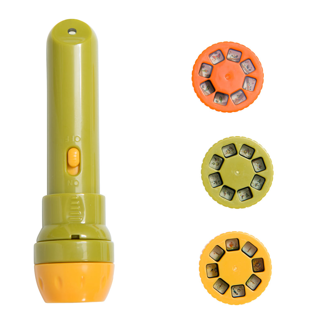An olive green and orange children's flashlight sits beside three colored discs with tiny illustrated images. The mood is playful and educational.