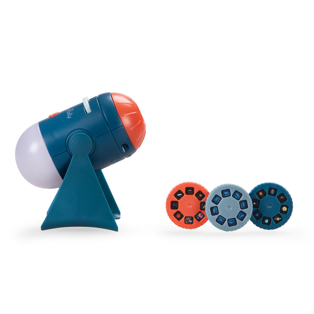 A small, colorful projector shaped like a rocket with a blue body, orange front, and a clear top, mounted on a blue stand against a white background.