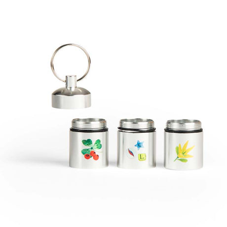 Moulin Roty Le Jardin du Moulin set of 3 silver metal treasure capsule containers with botanical nature illustrations.