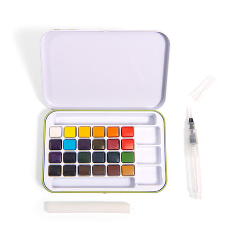 Open watercolor set with 24 colorful square pans inside a white case. Includes a water brush and sponge, creating a clean, organized artistic feel.
