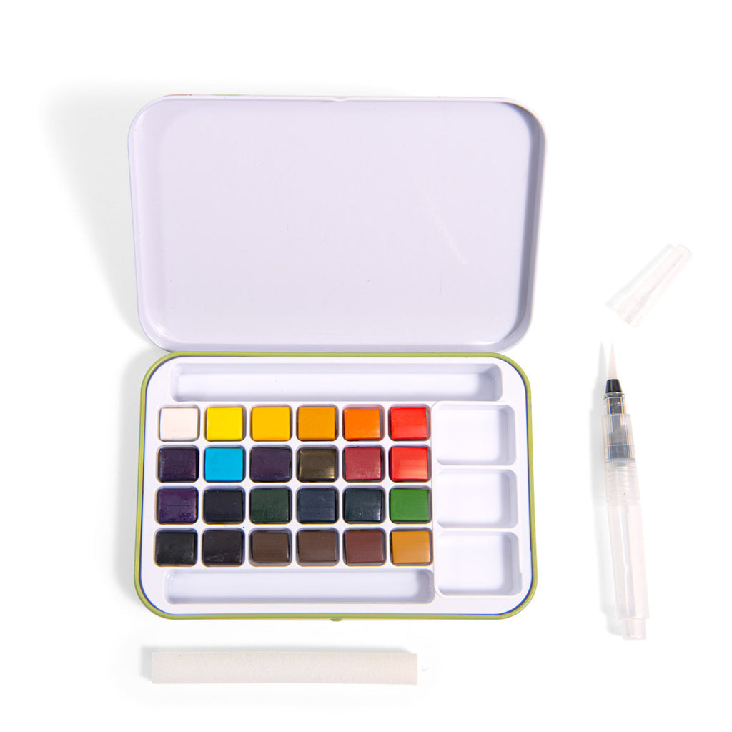Open watercolor set with 24 colorful square pans inside a white case. Includes a water brush and sponge, creating a clean, organized artistic feel.