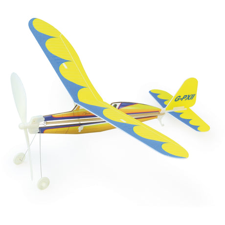 Yellow and blue rubber band powered balsa wood glider airplane toy with propeller and landing gear on white background.