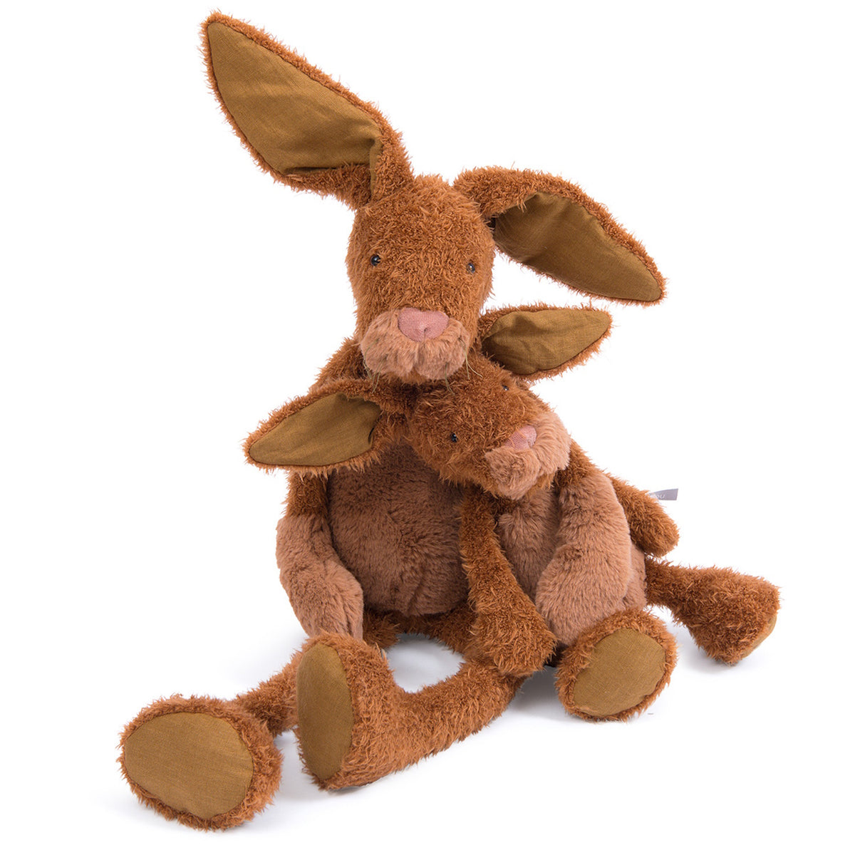 Two plush, brown stuffed rabbits sitting together, with the larger one hugging the smaller one from behind.
