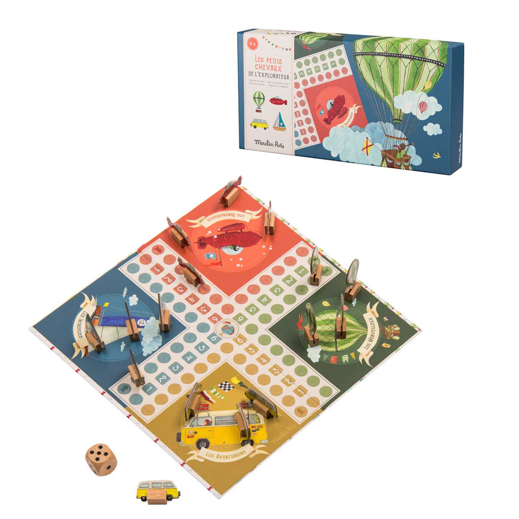 A colorful board game depicting four themed quadrants: red, green, blue, and yellow. Wooden pieces and a dice are placed around the board.