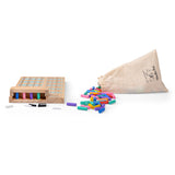 Wooden Mastermind-style board game with colorful pegs spilling out of a tan drawstring bag on a white background.