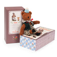 Moulin Roty Les Minouchkas Baba large bear plush toy sitting on a decorative gift box.