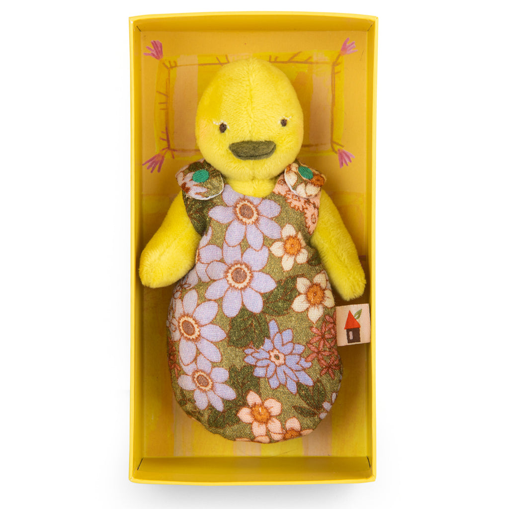 A yellow plush duck toy dressed in a floral-patterned outfit with purple and orange flowers. The toy has a simple, cheerful appearance.