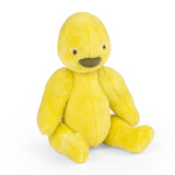Yellow plush duck toy Les Minouchkas Baby Rita sitting on white background.