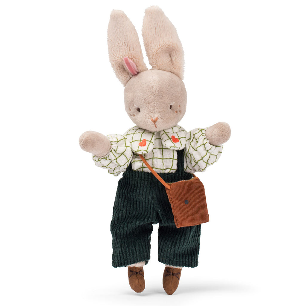 A plush bunny wearing a white grid-patterned shirt with tiny red birds, green corduroy overalls, and a brown fabric satchel, conveying a cozy feel.