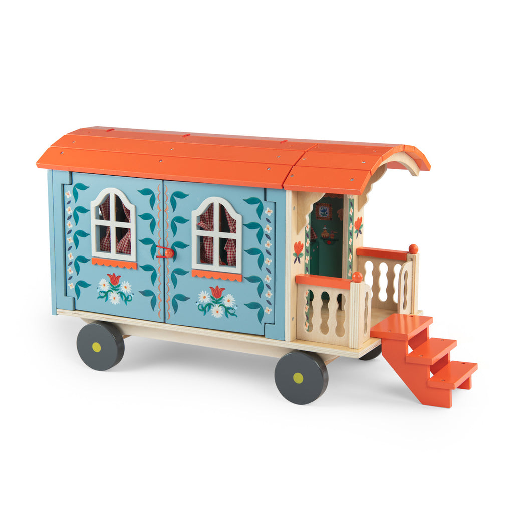 Toy wagon with a colorful design, featuring a blue body with floral patterns, an orange roof, and tiny stairs leading to a small porch on wheels.
